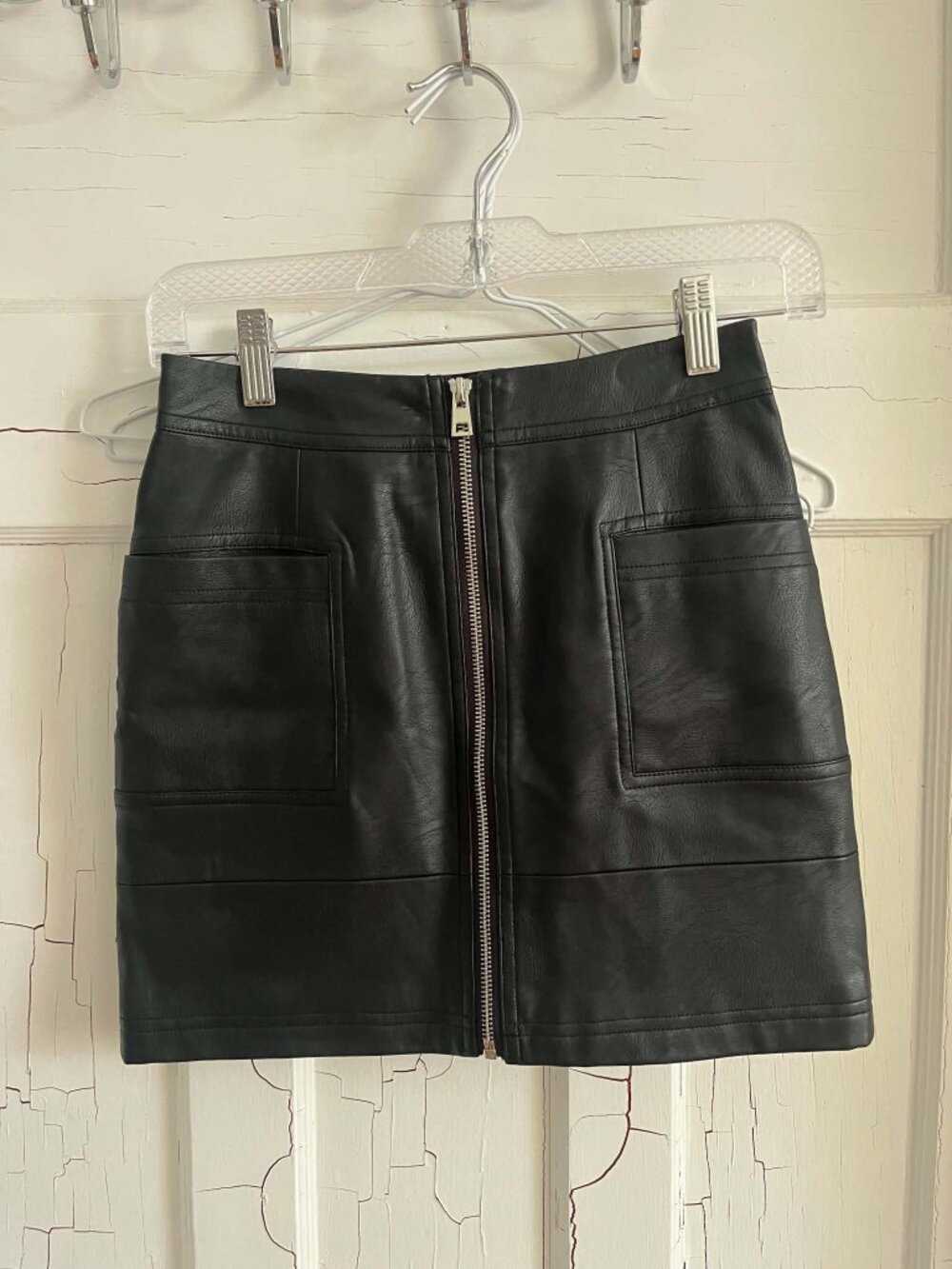 Black vegan leather mini skirt with pockets and zipper detail